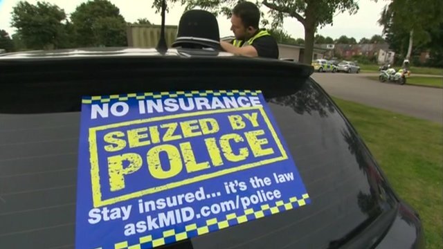 Seized car on a recovery truck after a police no-insurance stop
