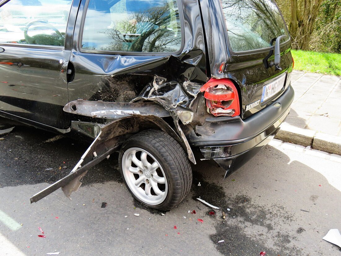 Damaged car being loaded onto a recovery truck after a collision